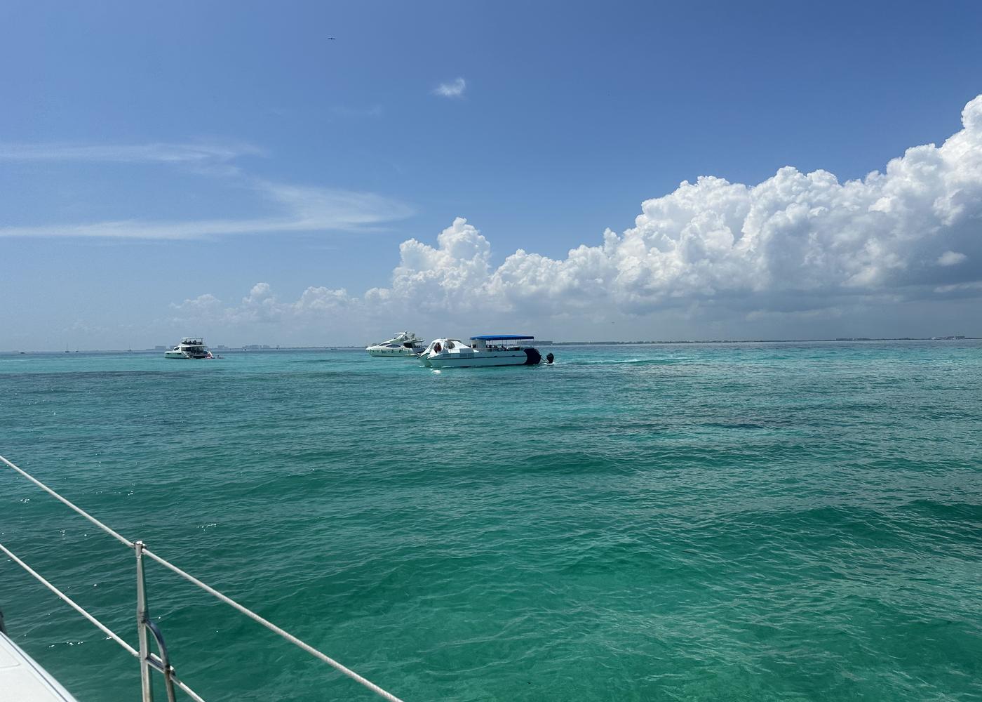 Boats at anchor over shallow turquoise water