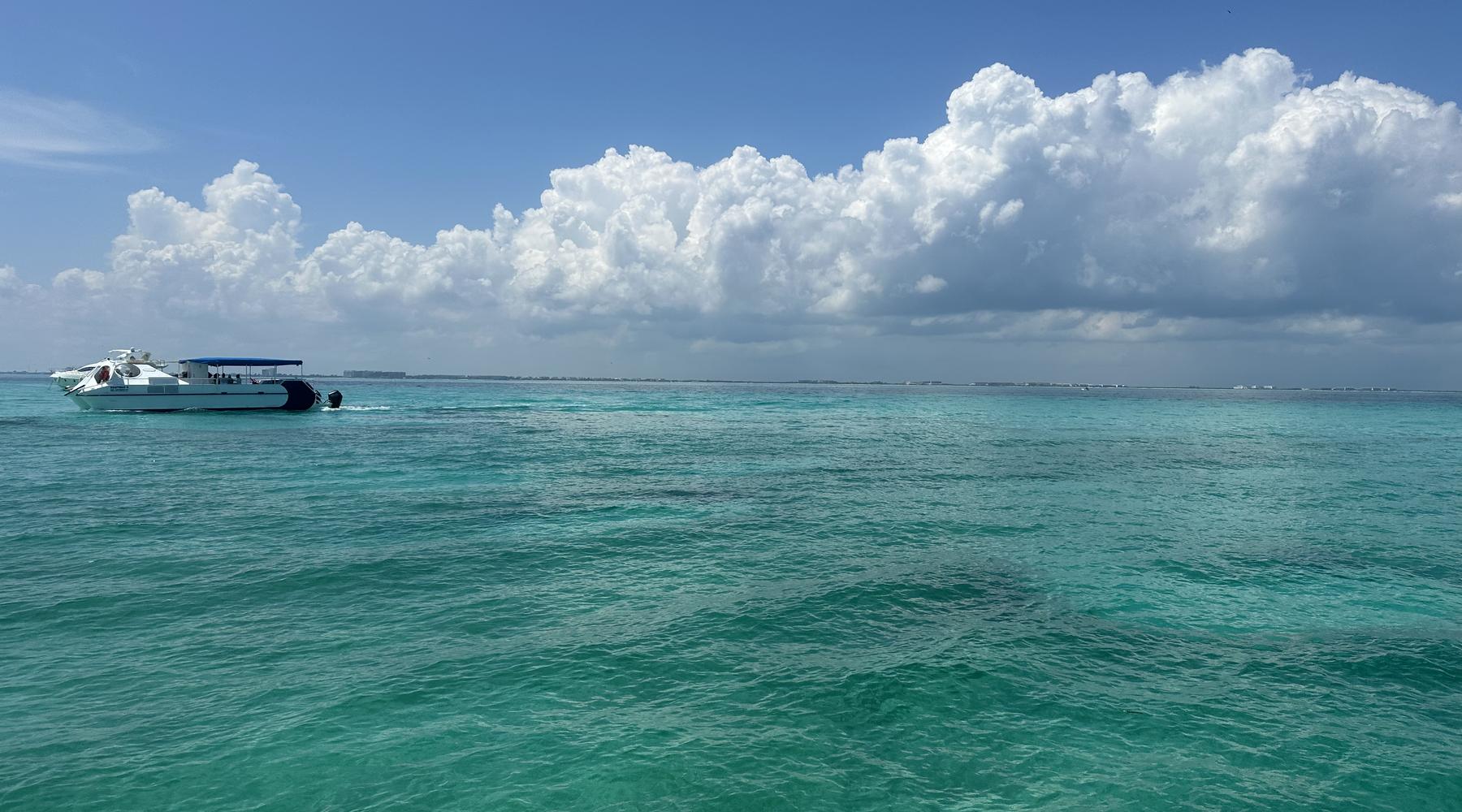A boat crossing open turquoise water